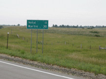 Highway sign west of Upper Cut Meat (Vetal 11 miles, Martin 30 miles).
